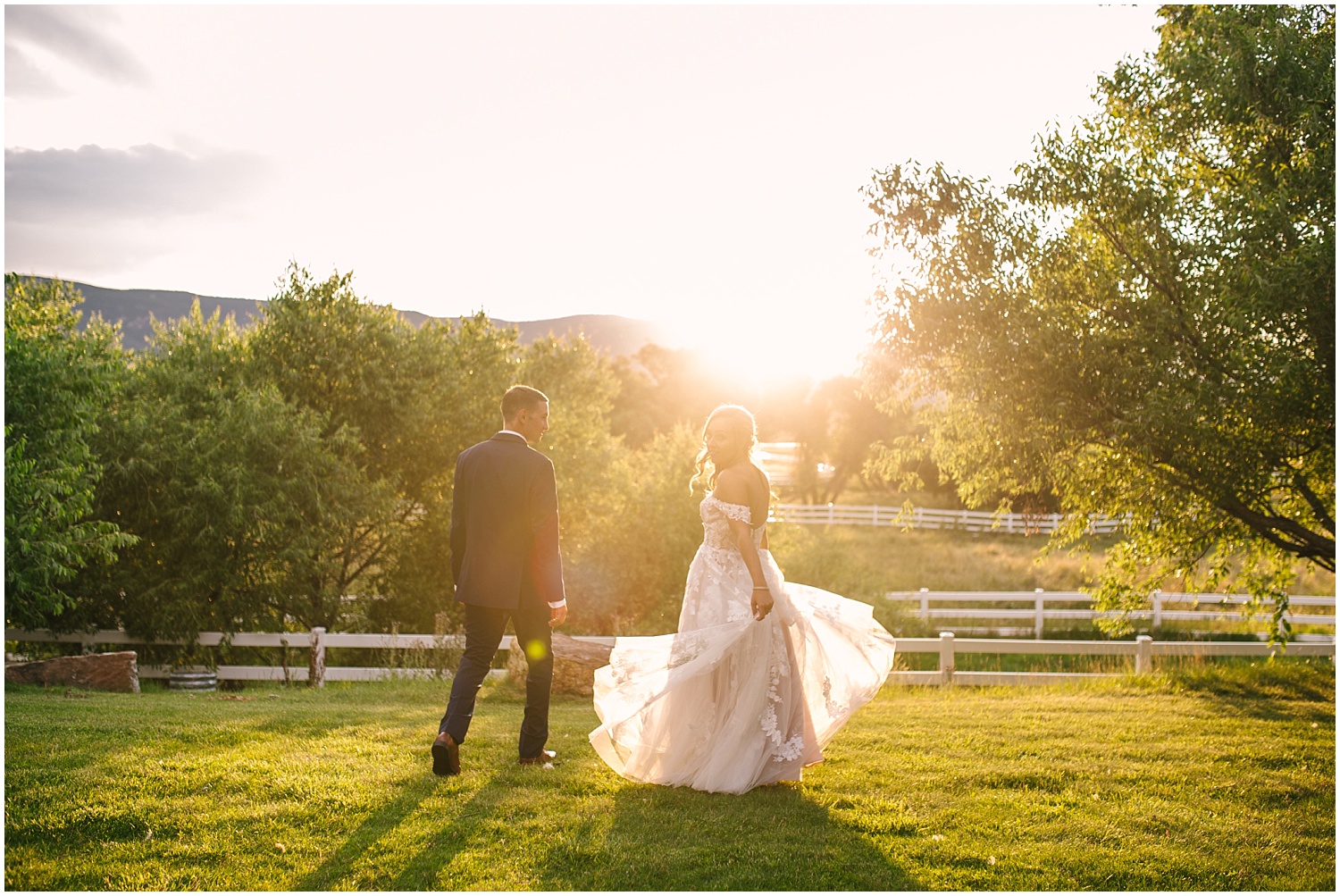 Bride and groom walking through fields at Crooked Willow Farms at golden hour