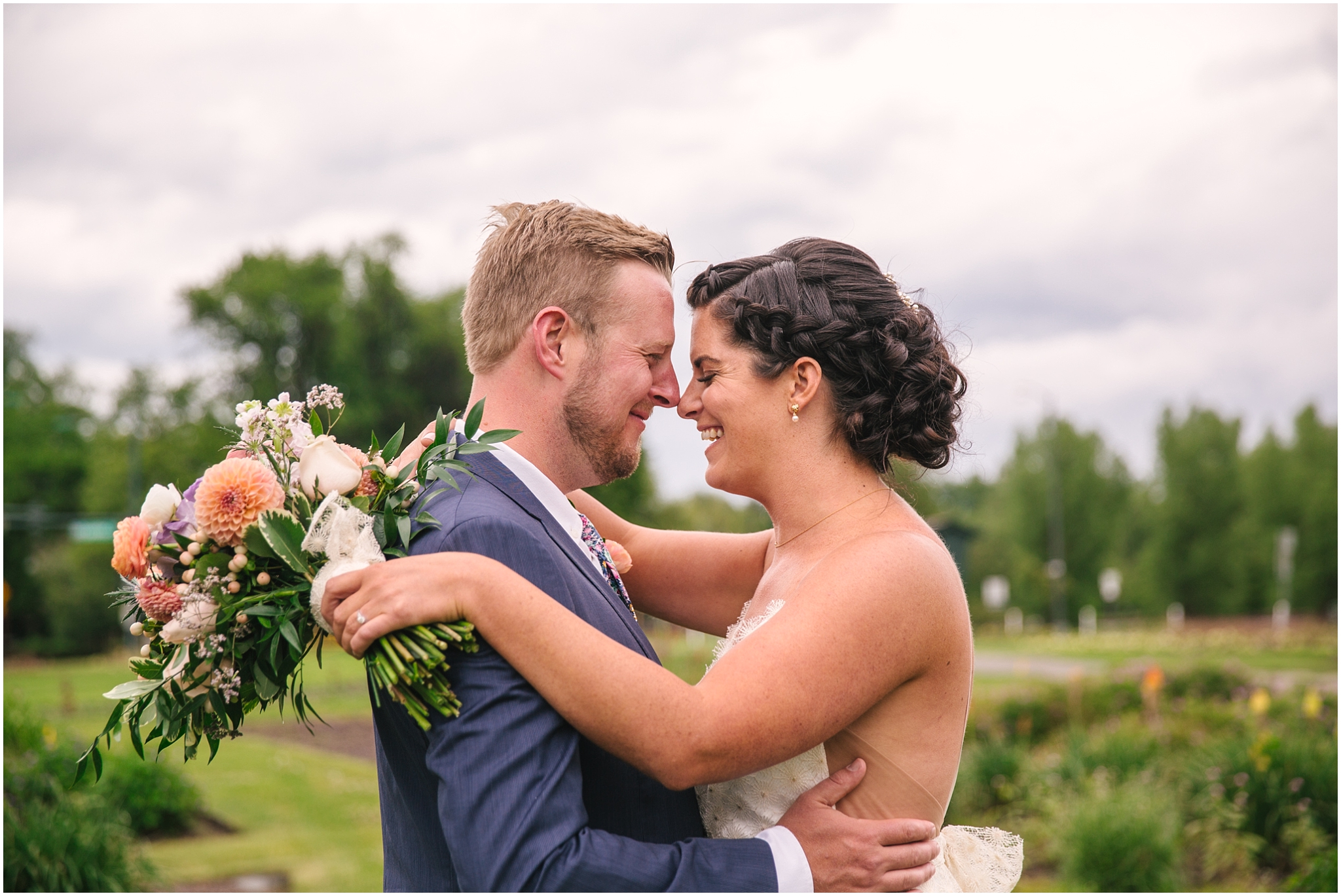 Bride and groom nuzzle each other in Washington Park garden in Denver Colorado
