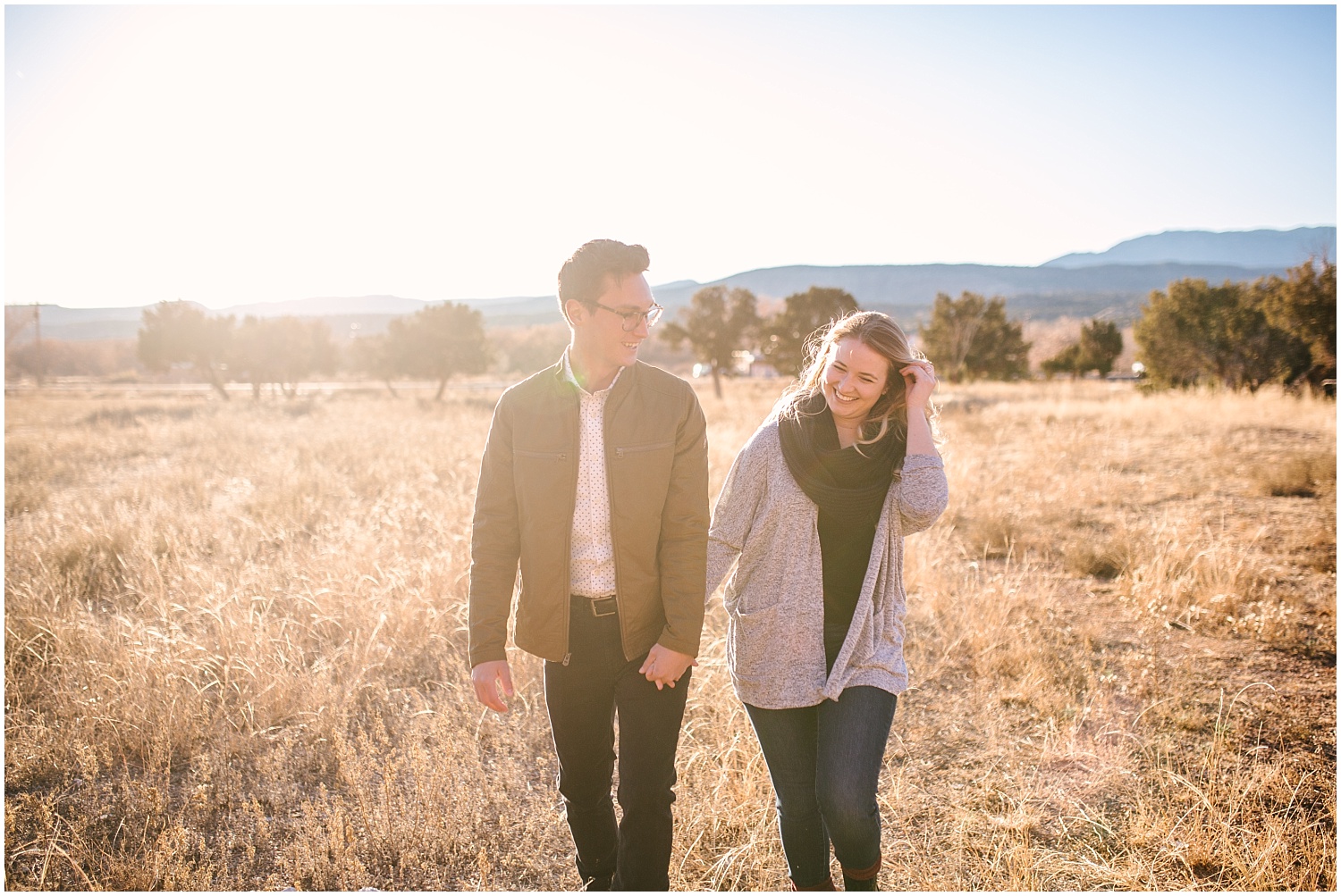 couple walks in golden light at Jemez Red Rocks New Mexico