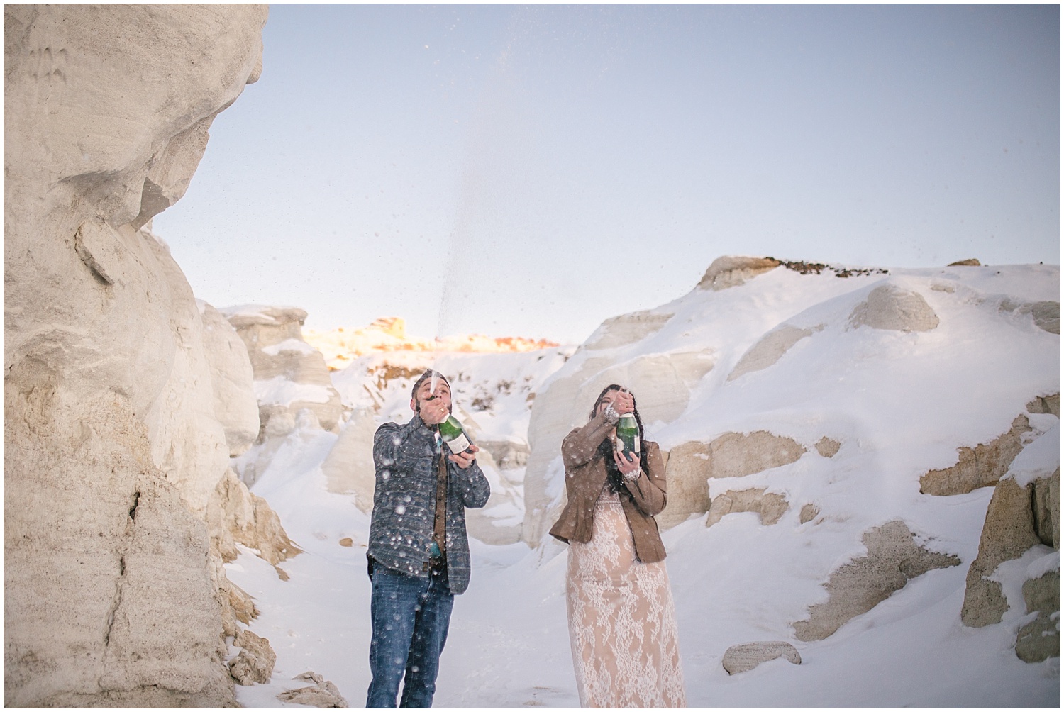Bride and groom celebrate with champagne at winter Paint Mines elopement in Colorado