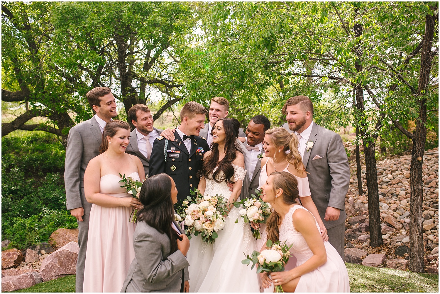 Wedding party surrounds the bride and groom with love at Creekside Event Center wedding