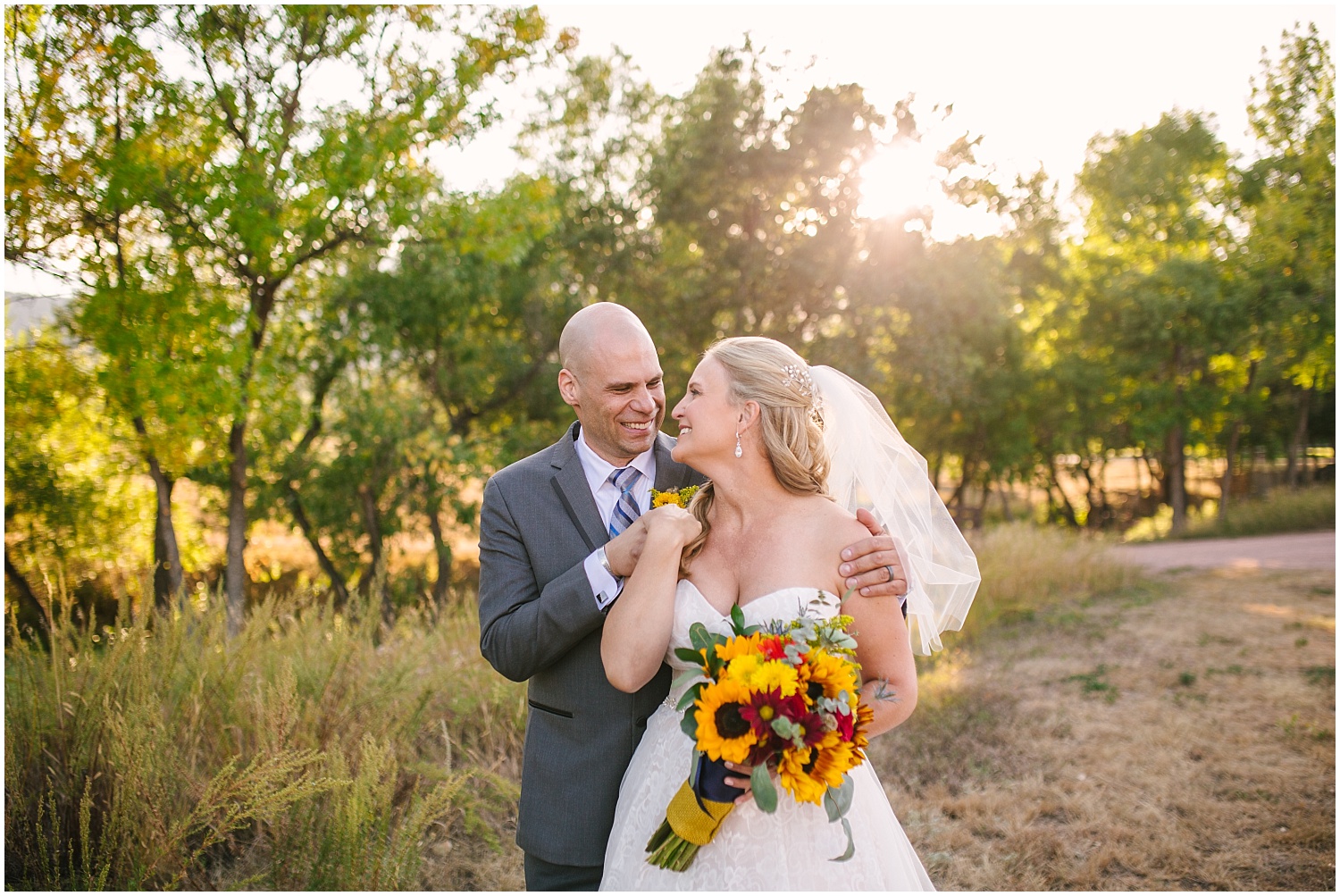 Bride and groom embrace at golden hour at Bear Creek Park in Colorado Springs