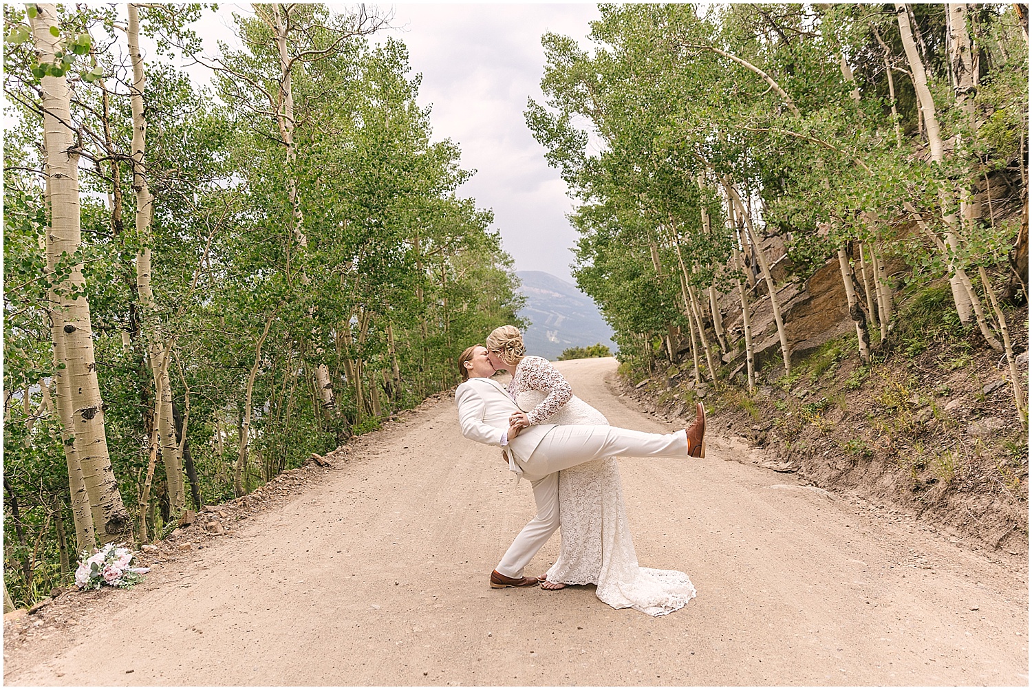 Wedding couple kissing in the road up Boreas Pass in Breckenridge, Colorado