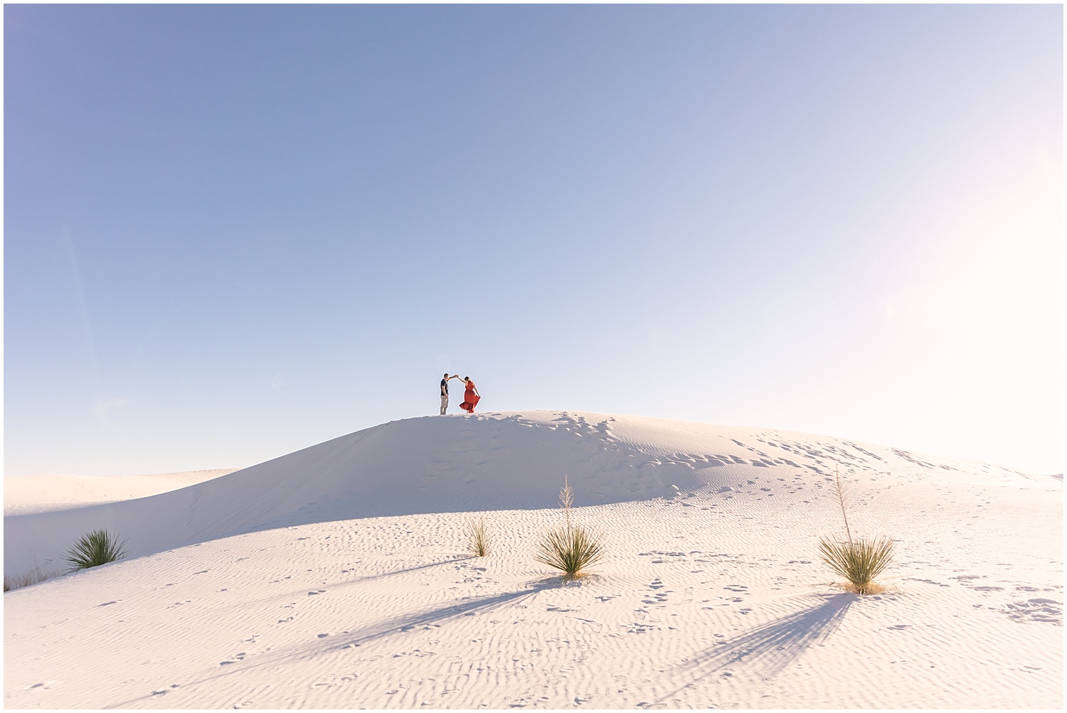 Couple dancing on a hill at White Sands adventure engagement session