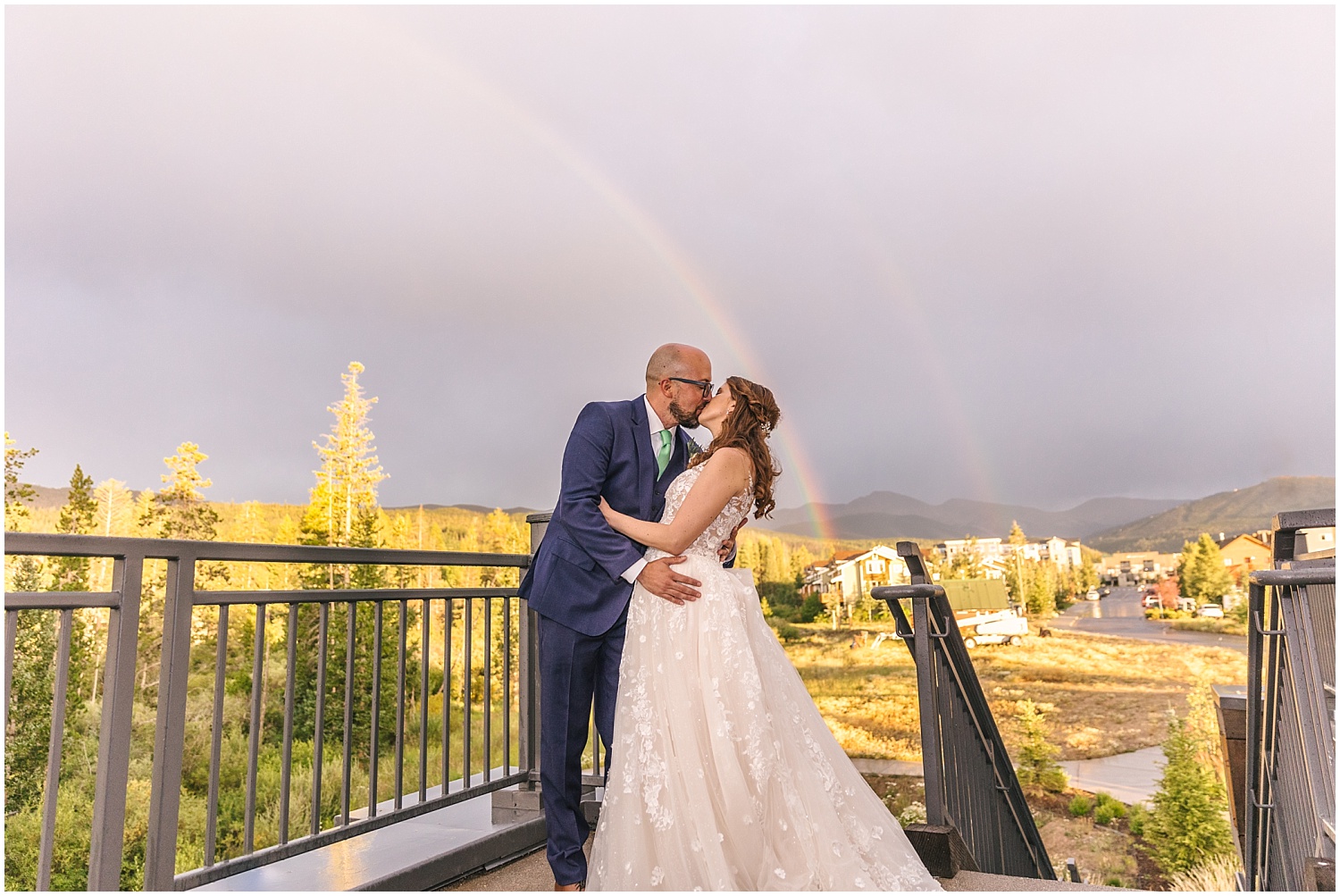 Bride and groom under double rainbow at Winter Park wedding reception at Headwaters Center
